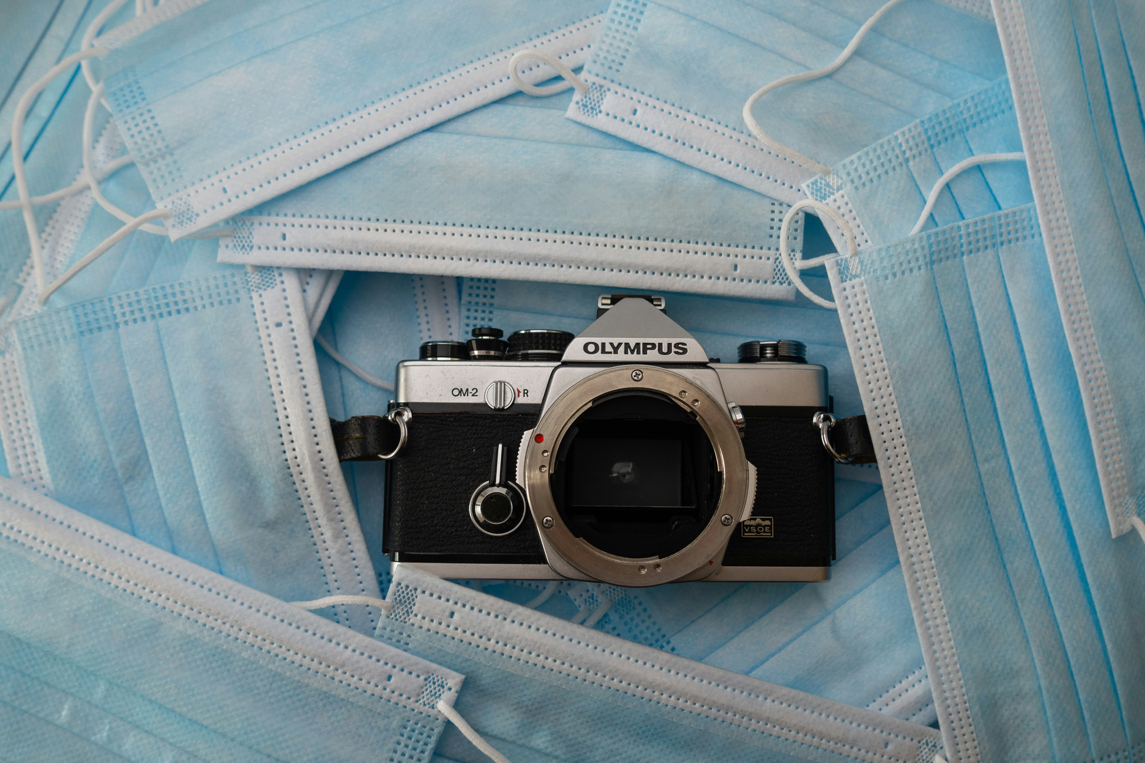 black and silver nikon dslr camera on blue textile